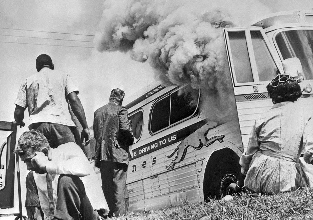 Figure 6-3: Freedom riders watch a bus that was set on fire in Anniston, Alabama.